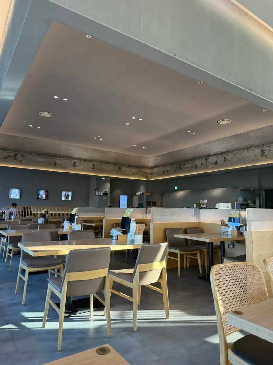 Dining hall interior with a full wall of windows