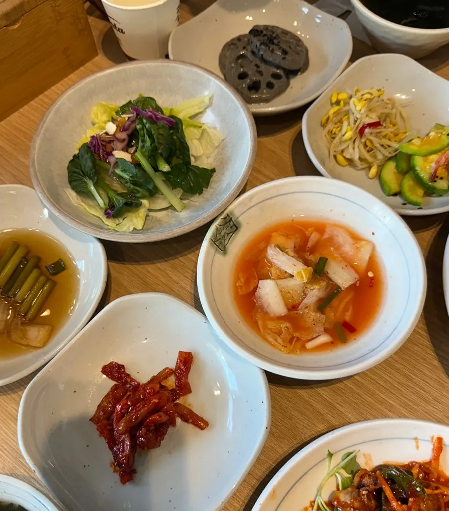 Cockle bibimbap and side-dish spread