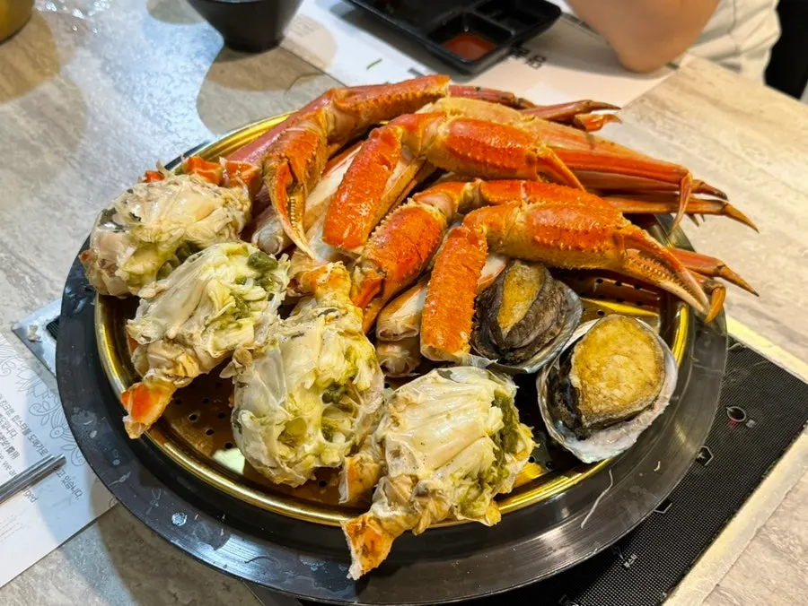 Two premium bakdal snow crabs served in a steamer