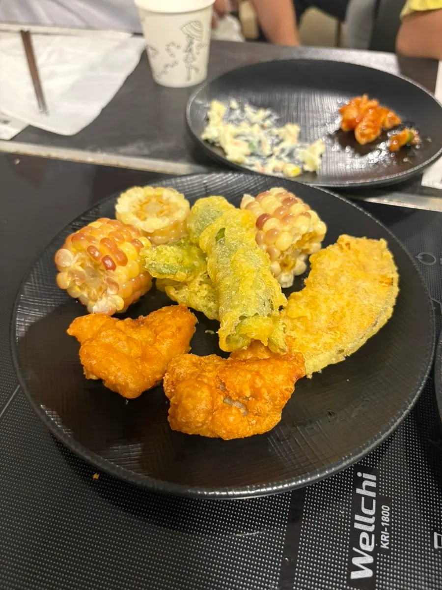 A plate of fried food and glutinous corn brought back to the table