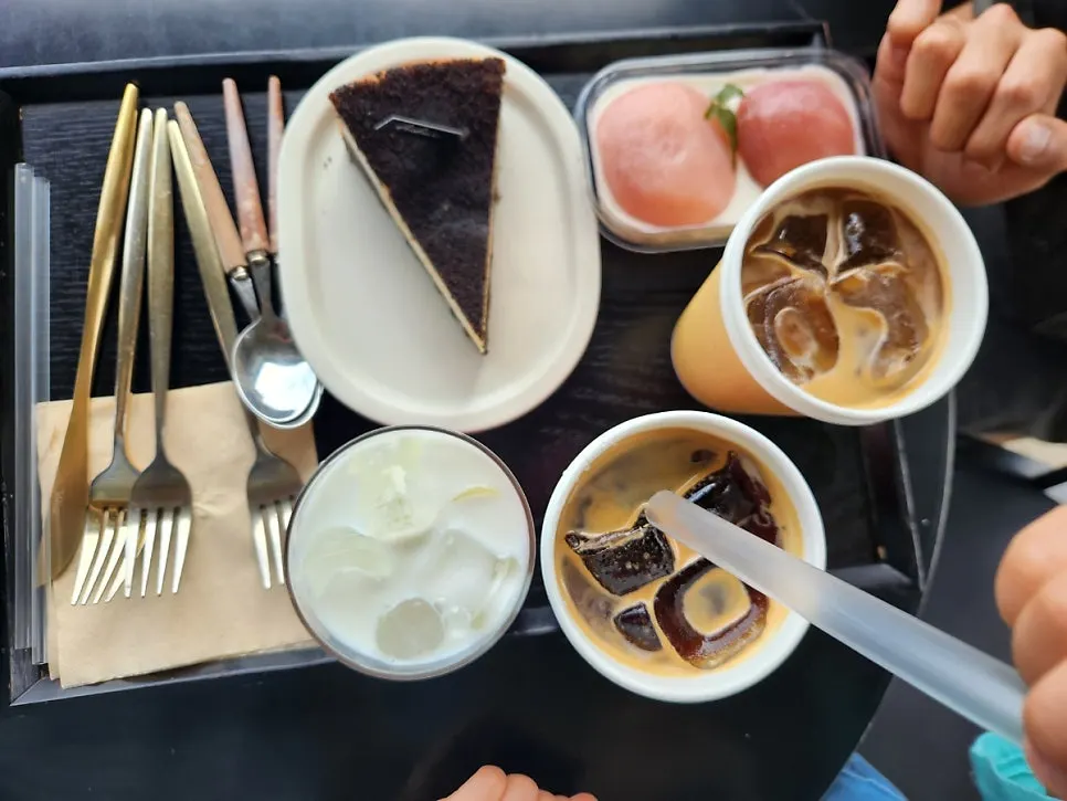 Table set with a royal vanilla bean latte, Americano, and strawberry latte