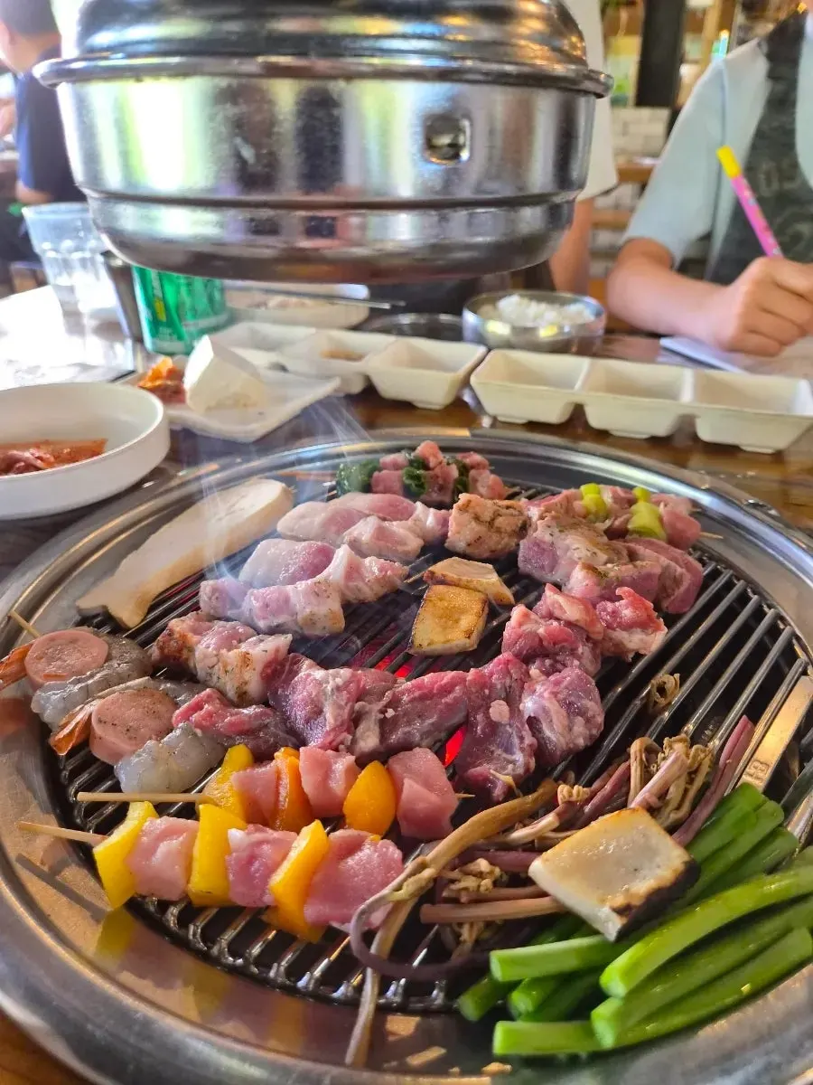 Pre-grilled meat cooking on the grill