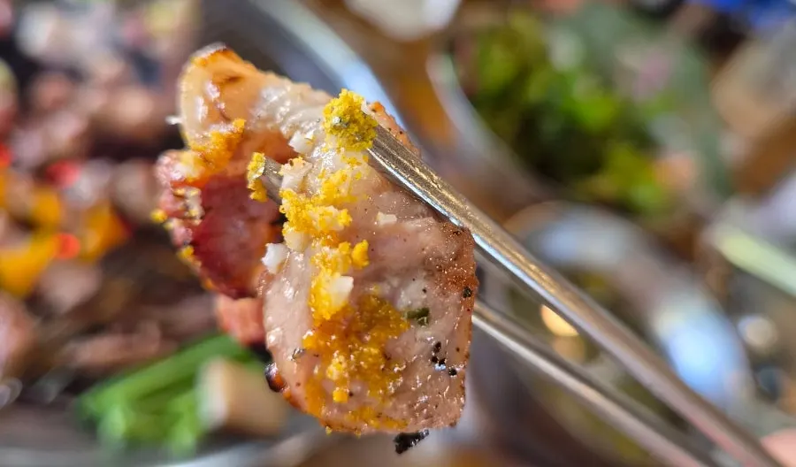 Pre-grilled pork belly dipped in sauce
