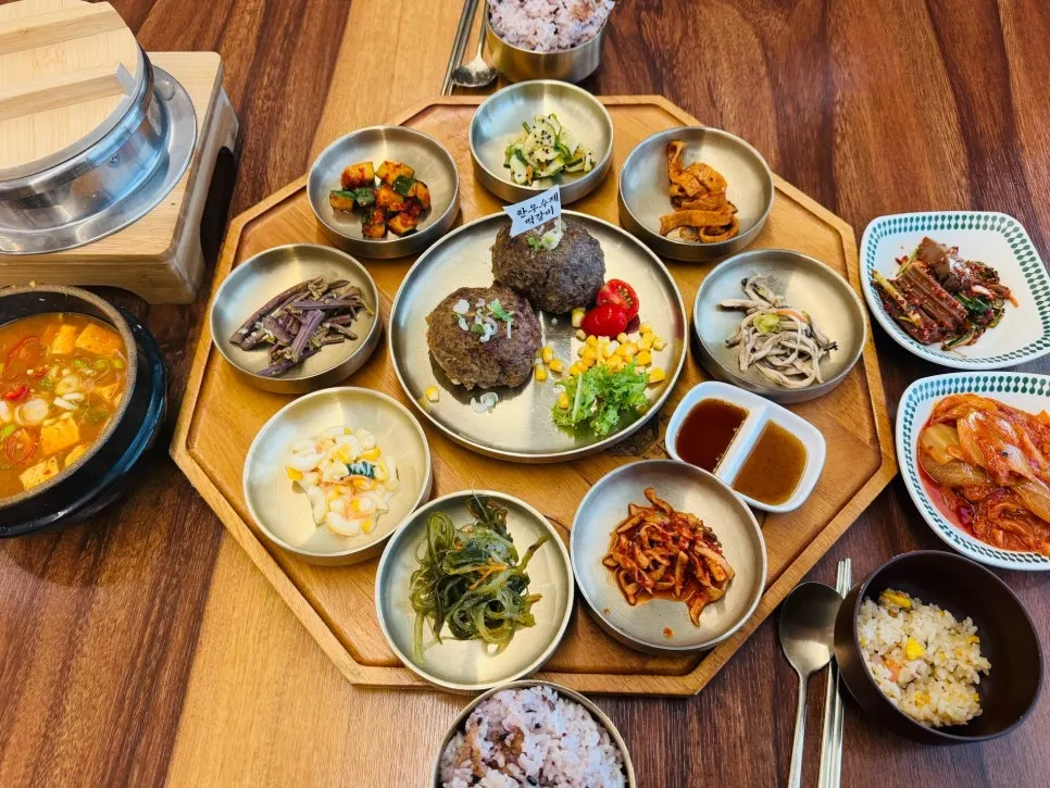 Generous table spread with tteokgalbi and side dishes