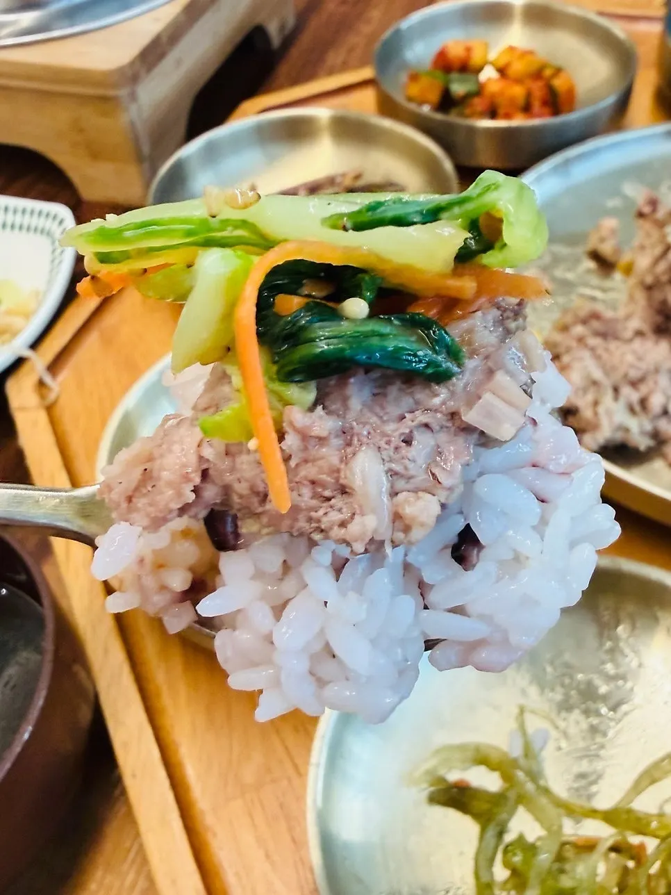 A spoonful of Dongam tteokgalbi with hotpot rice