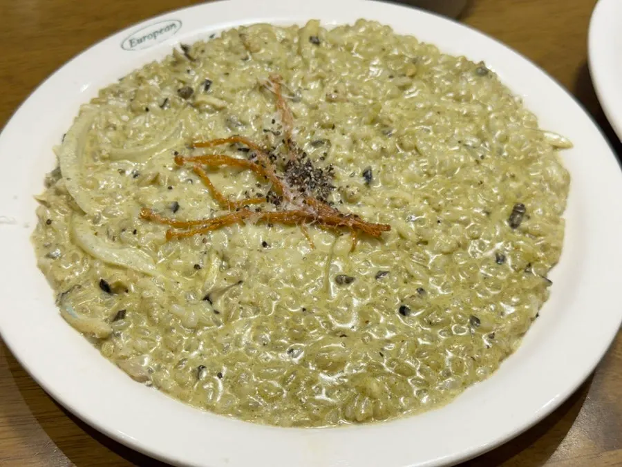 Abalone cream risotto topped with fried enoki mushroom