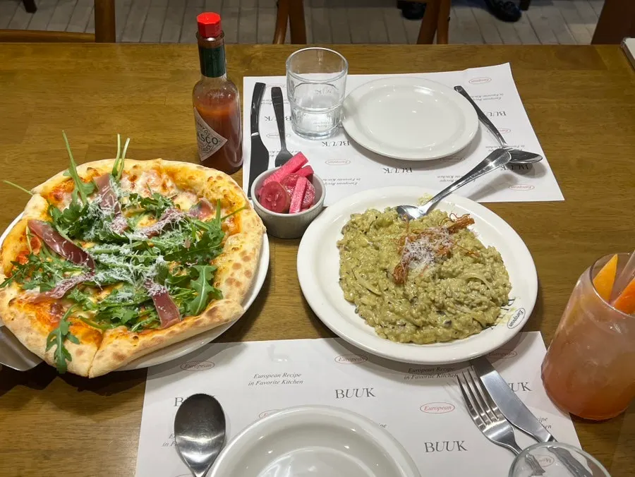 Table set with both the risotto and the pizza together