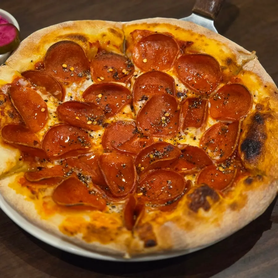 Pepperoni pizza packed with pepperoni edge to edge