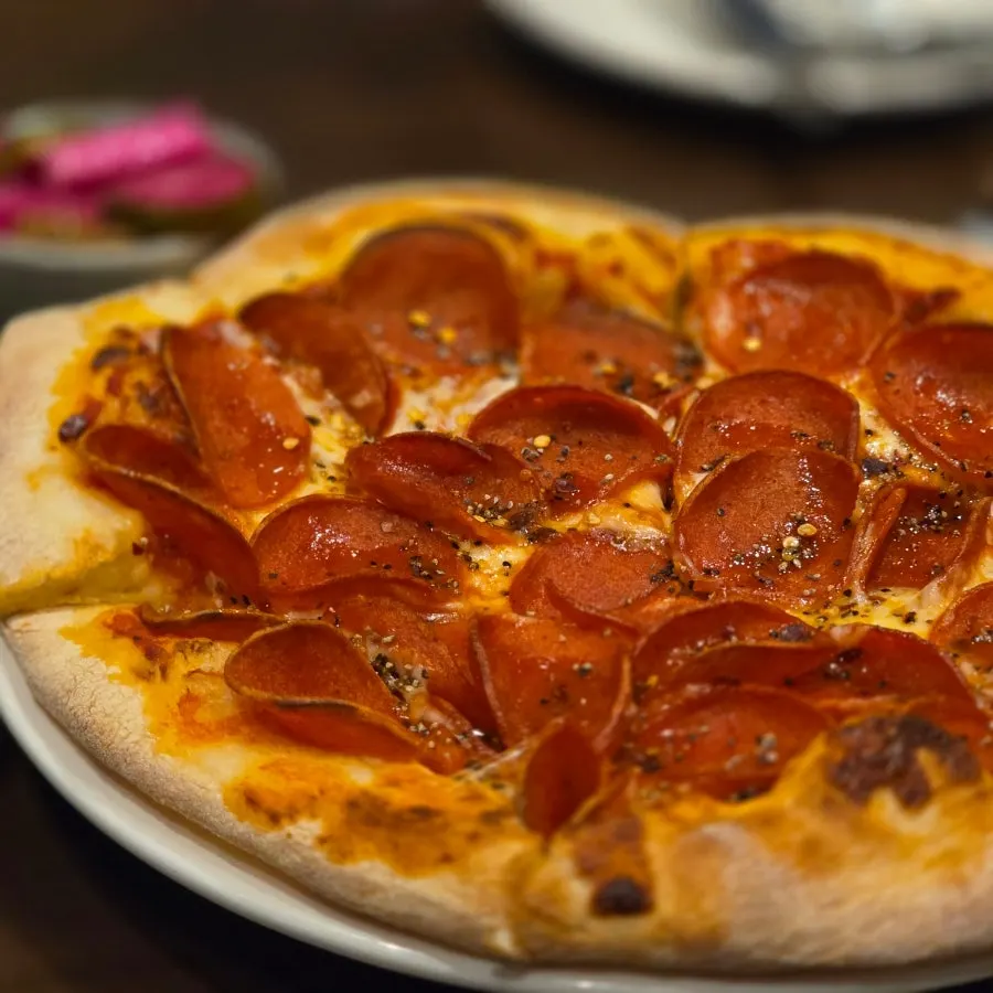 Pepperoni pizza cut into six slices