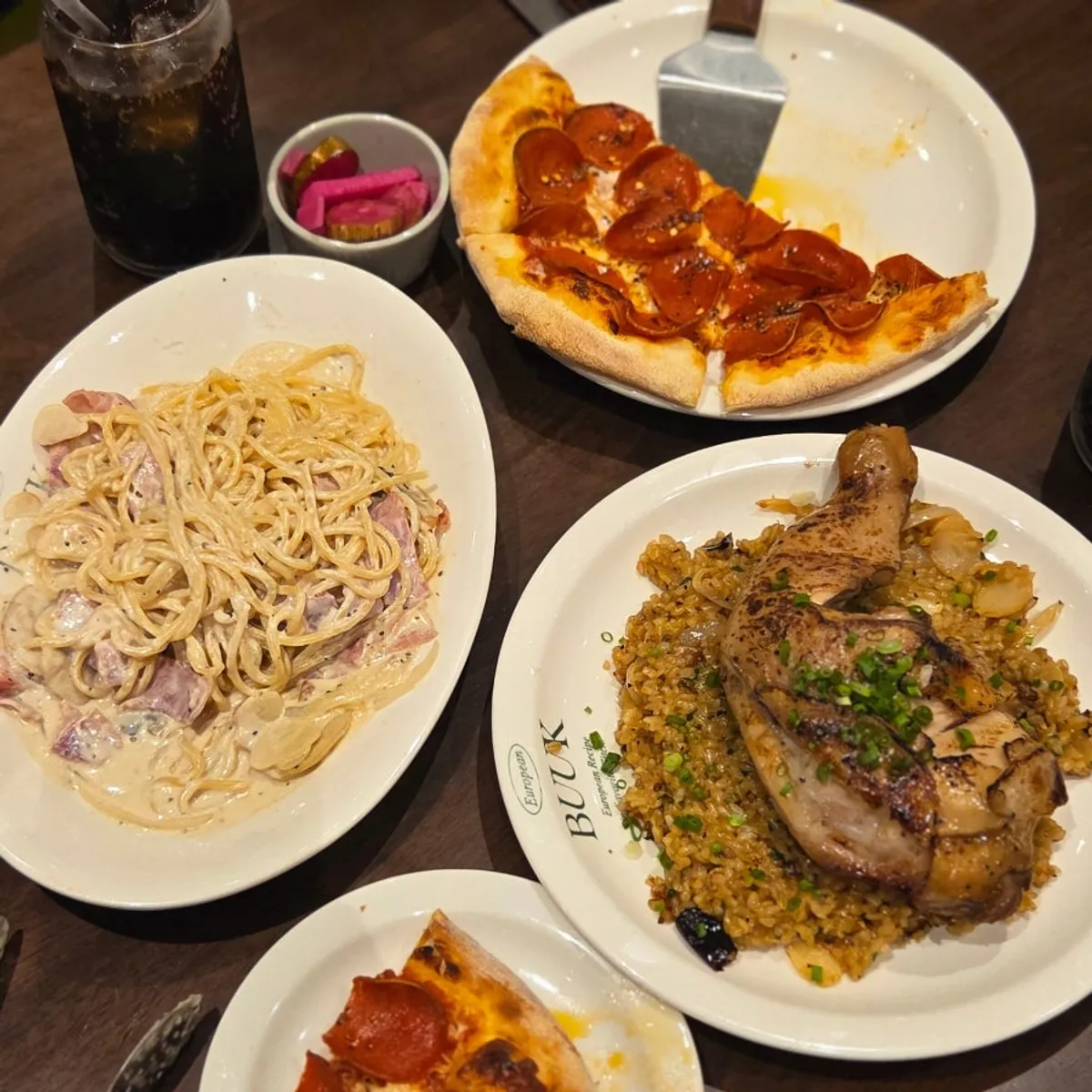 Pasta, pizza and pilaf all laid out together for lunch
