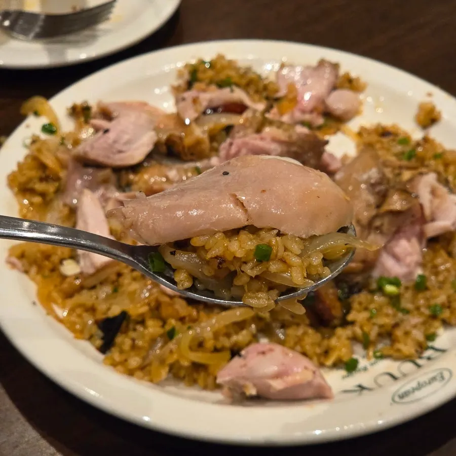 Chicken leg meat piled onto spicy kung pao pilaf