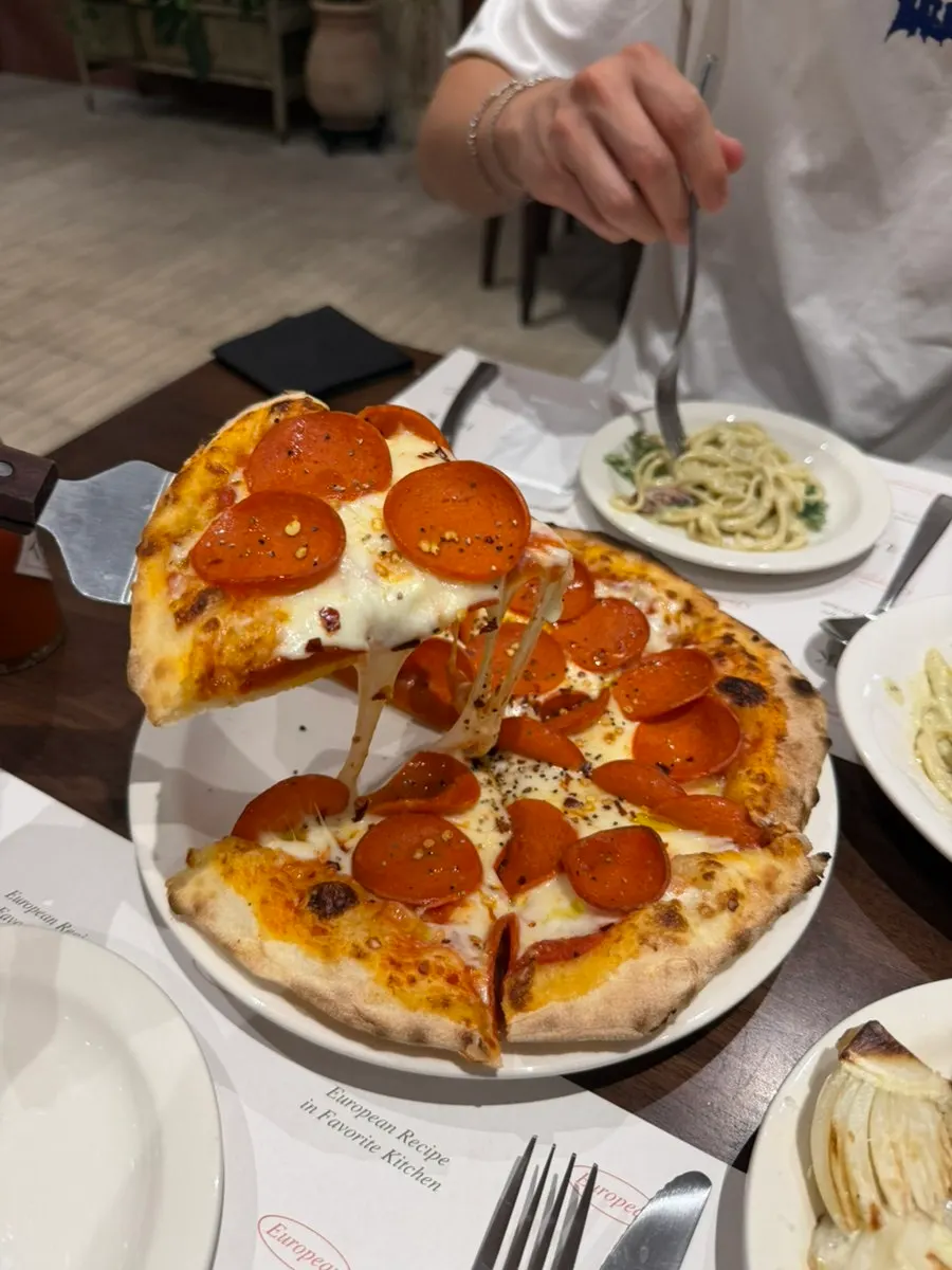 Cross-section of pepperoni pizza with fluffy pan-pizza dough