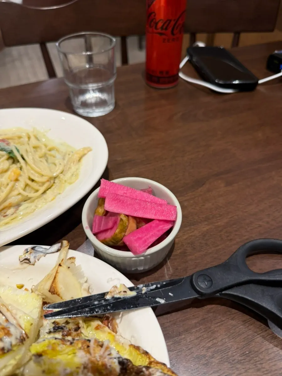 Crunchy pickles served alongside the pizza