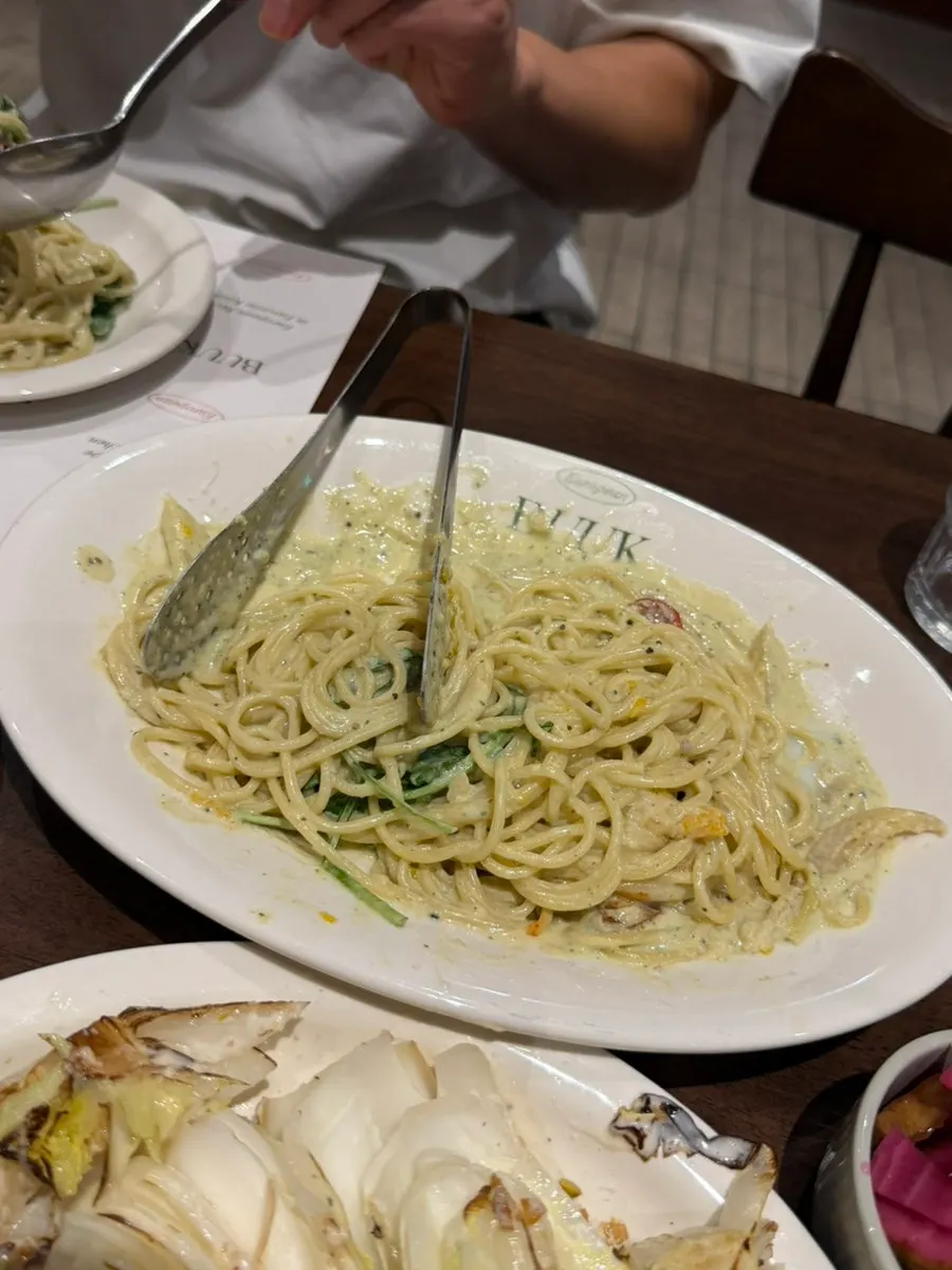 Close-up of pasta noodles coated in cream sauce