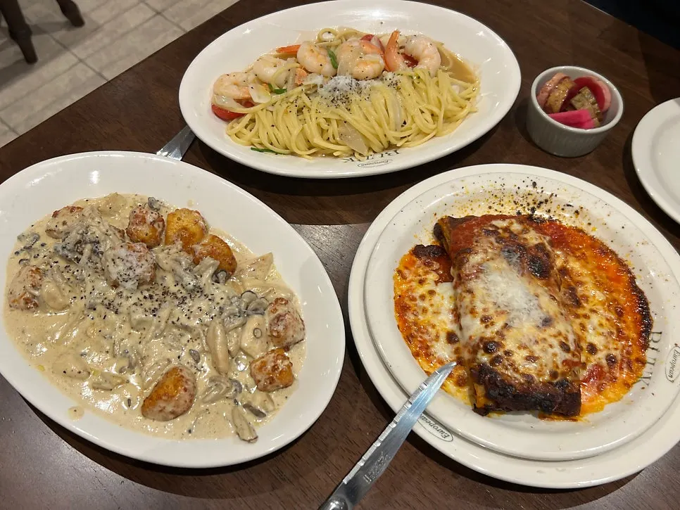A table spread of pasta, gnocchi, and lasagna