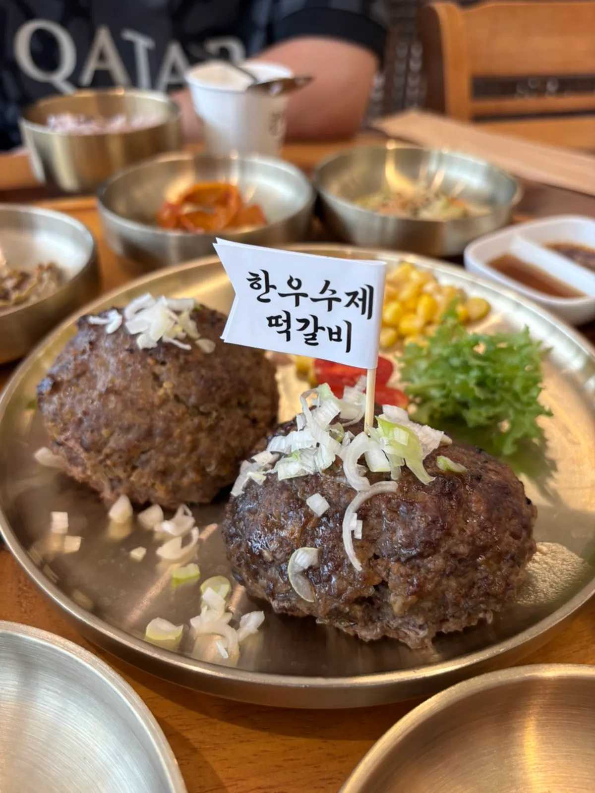 Vertical photo of the Dongam Tteokgalbi set meal table setting