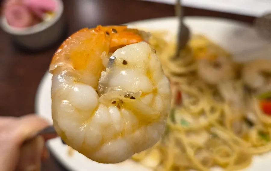 Close-up of the large shrimp on top of the pasta