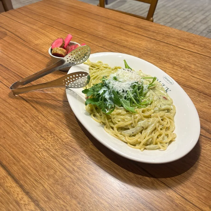 A plate of Bueokgan's basil pesto cream pasta