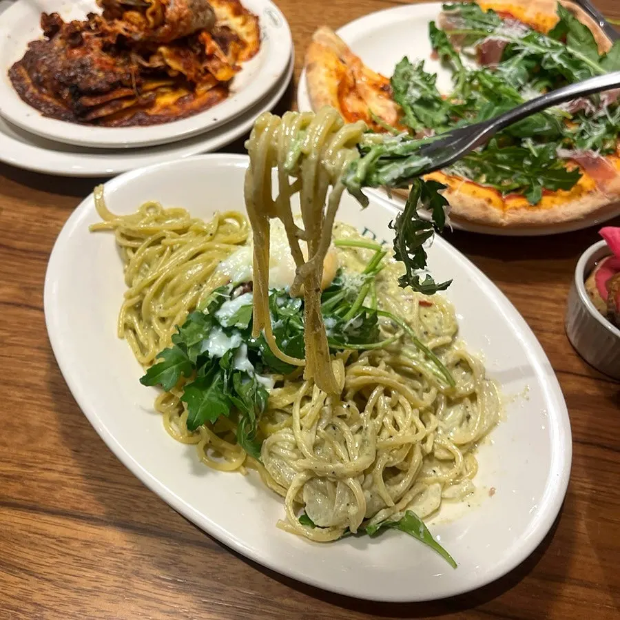 Basil pesto pasta noodles coated in rich cream sauce
