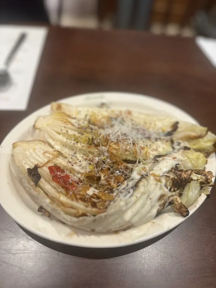 Serving out the napa cabbage Caesar salad