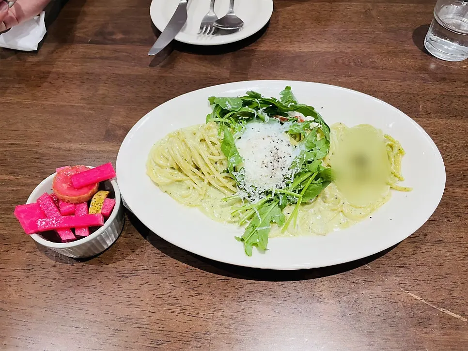 Basil pesto cream pasta topped with a soft-boiled egg