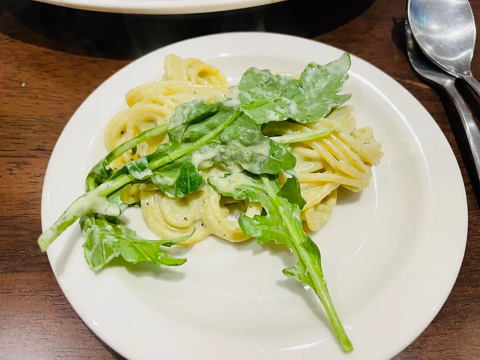 Basil pesto cream pasta mixed with the egg yolk