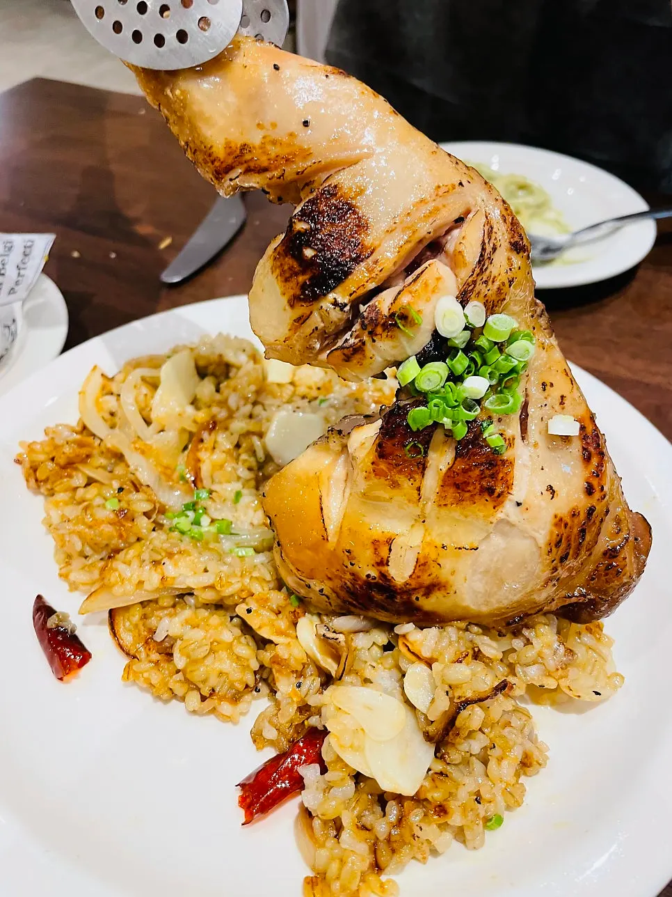 Close-up of the well-roasted chicken leg on the kung pao chicken pilaf