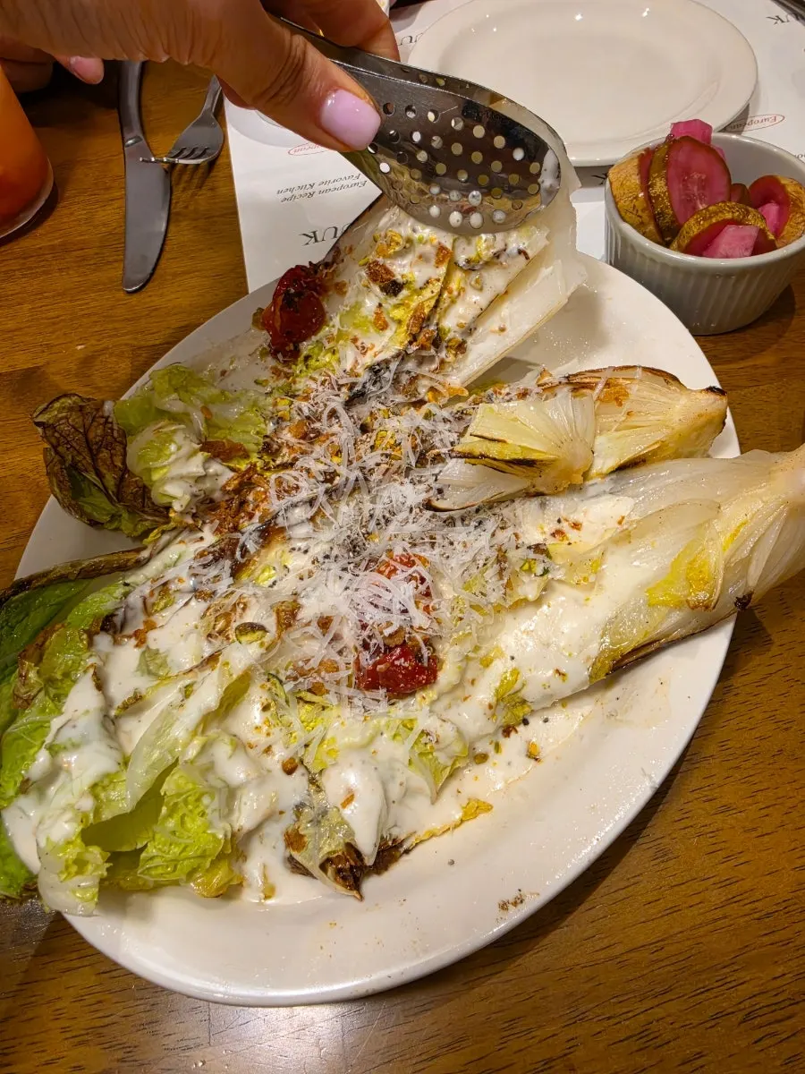 Whole albaechu Caesar salad served at the table