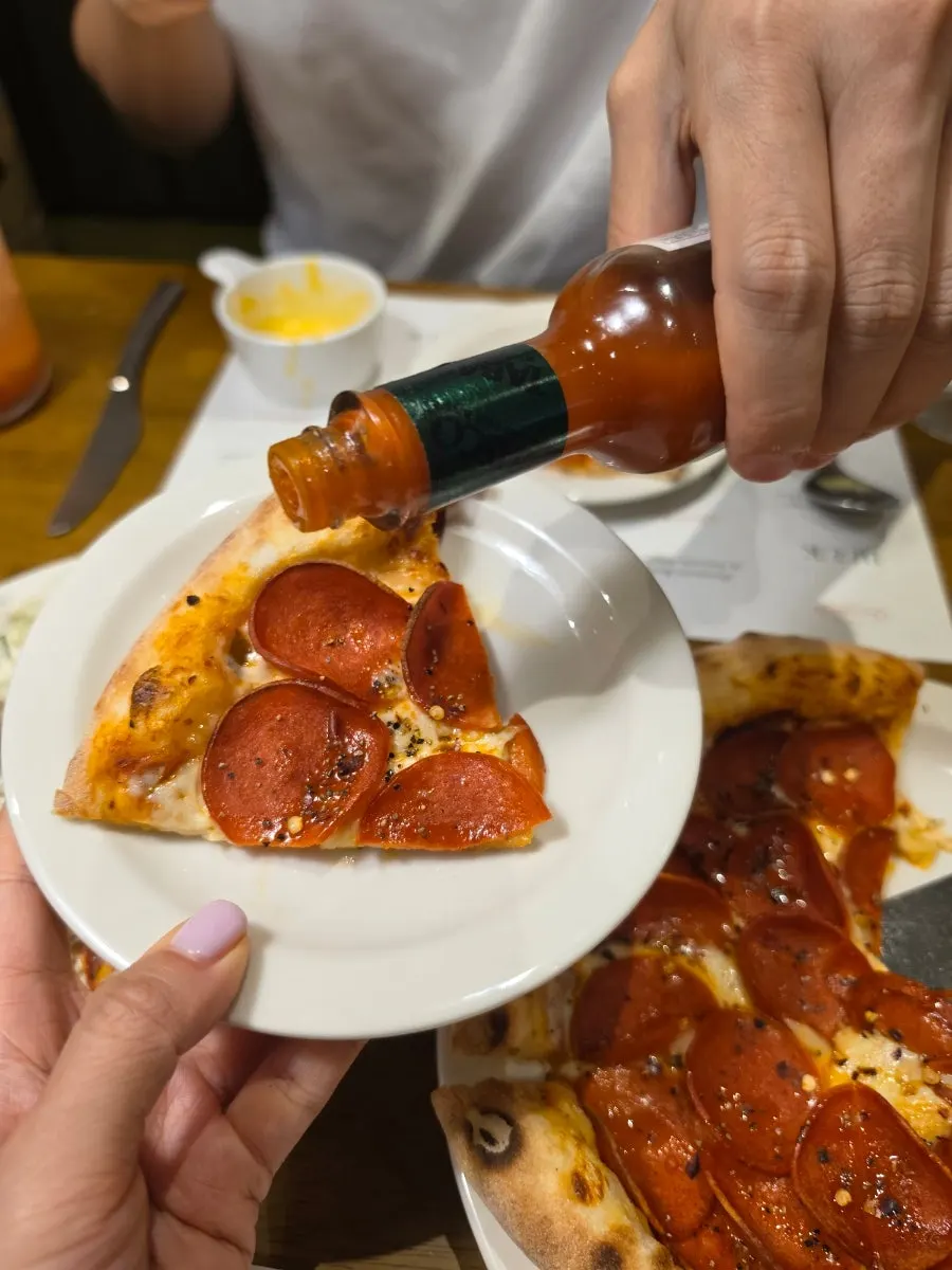 Lifting up a slice of pizza