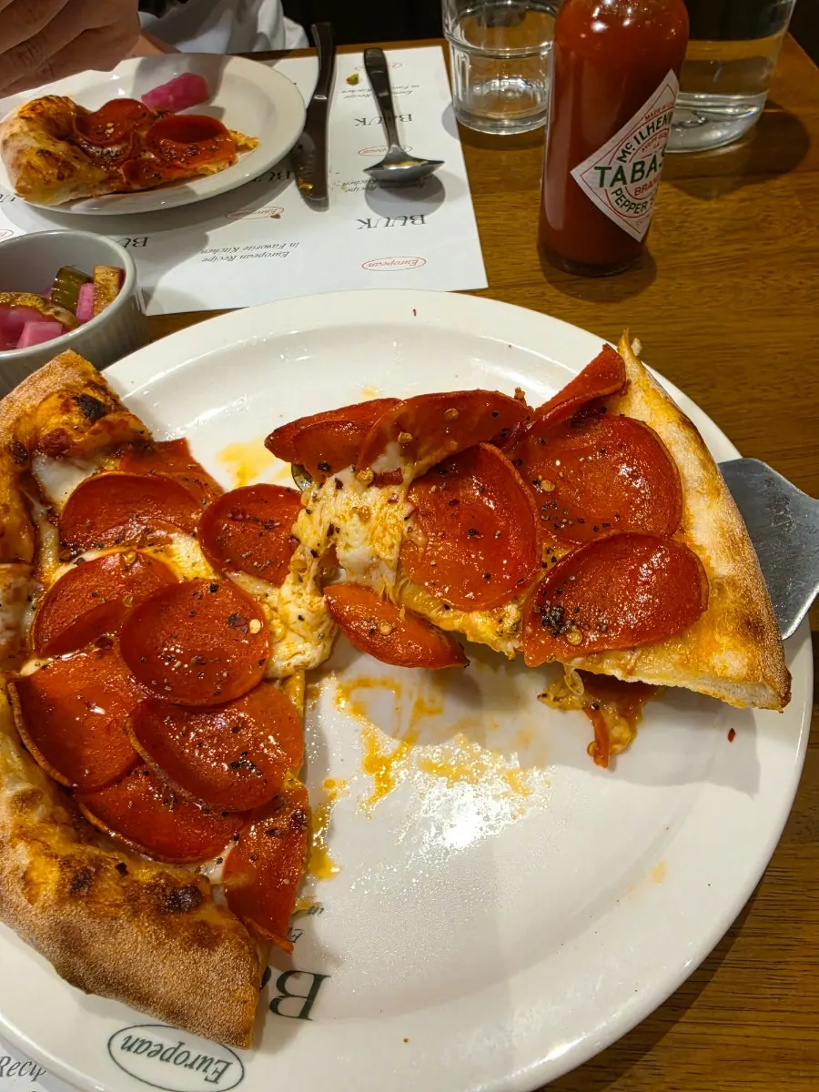 Cheese stretching from a pepperoni pizza slice