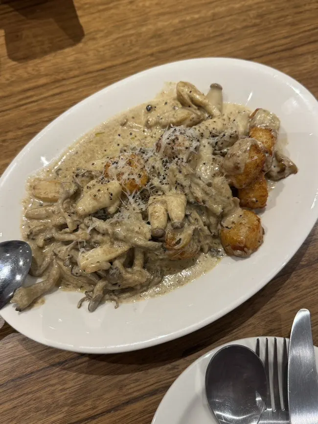 Napa cabbage Caesar salad, shrimp anchovy pasta, and truffle mushroom gnocchi laid out together