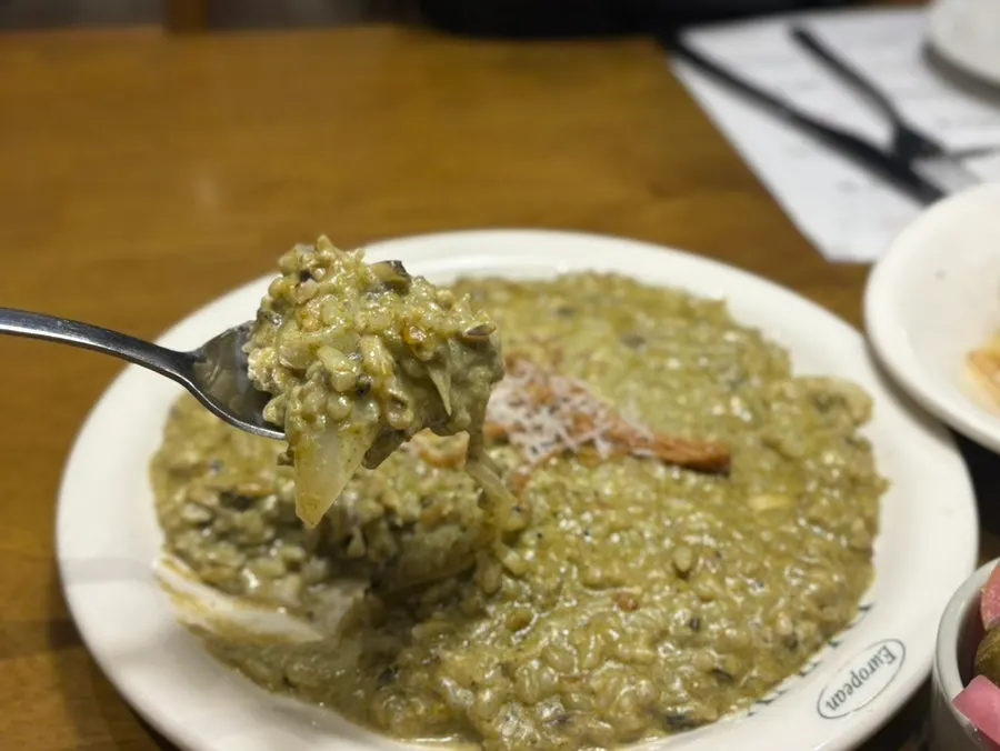 Abalone risotto topped with grilled enoki mushroom