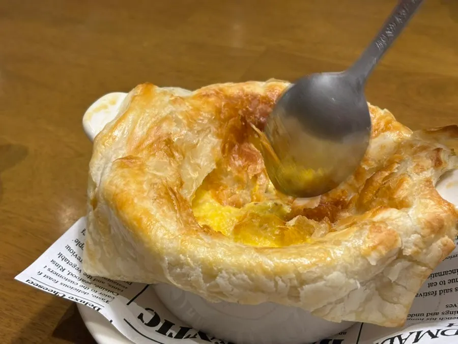 Pastry soup with bread covering the cup