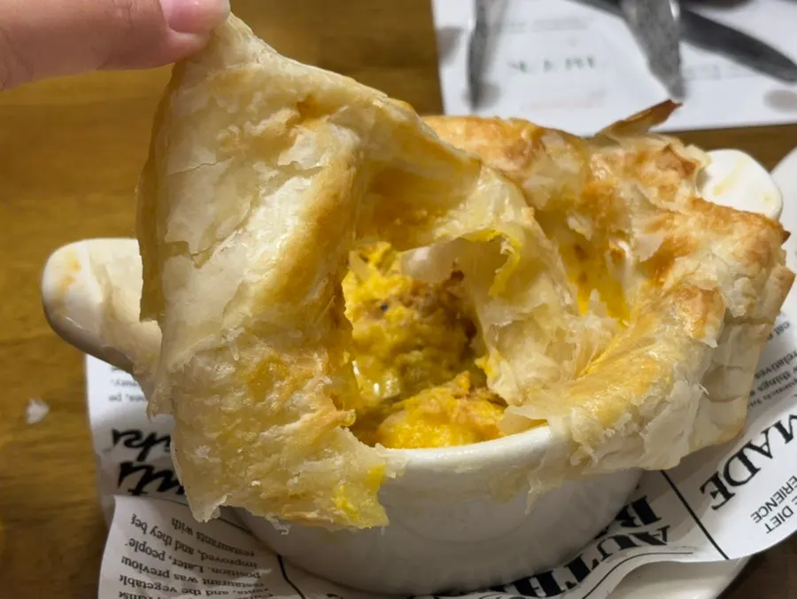 Sweet pumpkin soup revealed inside the cracked pastry