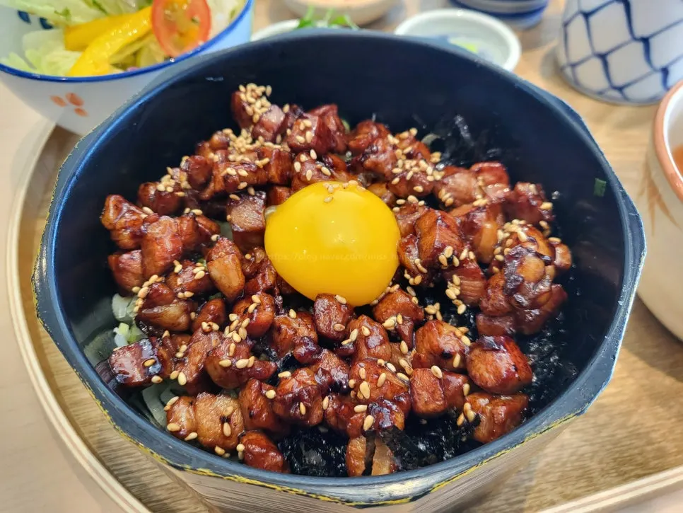 Butadon topped with an egg yolk