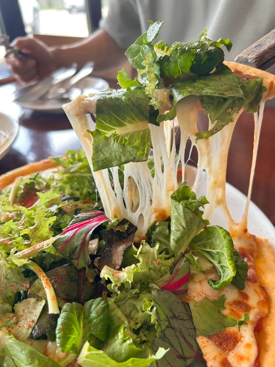 Shrimp pizza piled with salad