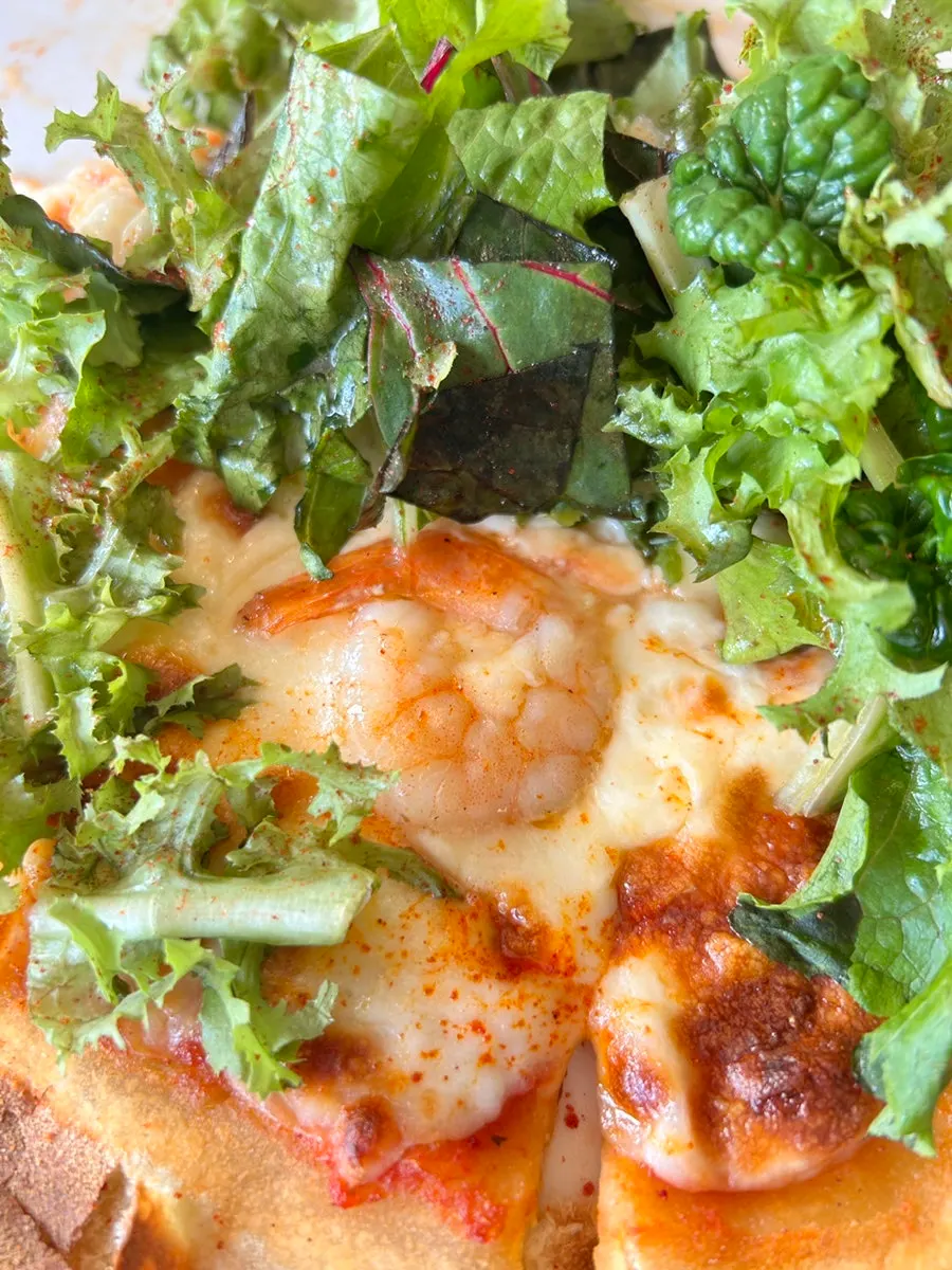 Salad pizza topped with cheese