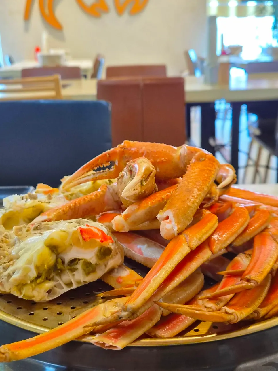 Three family members gathered around the crab table
