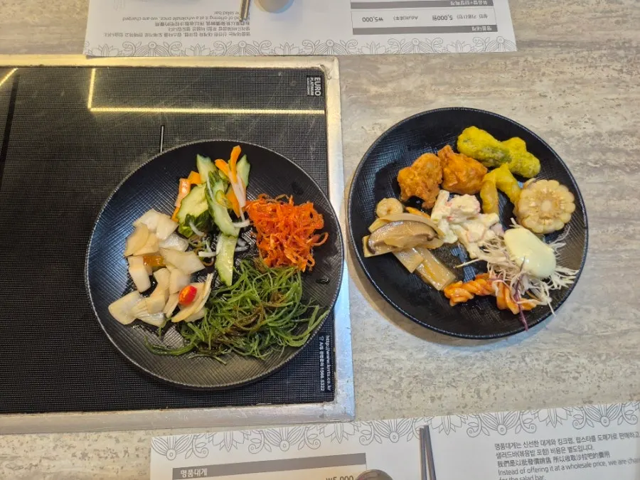 Assorted dishes set out at the salad bar