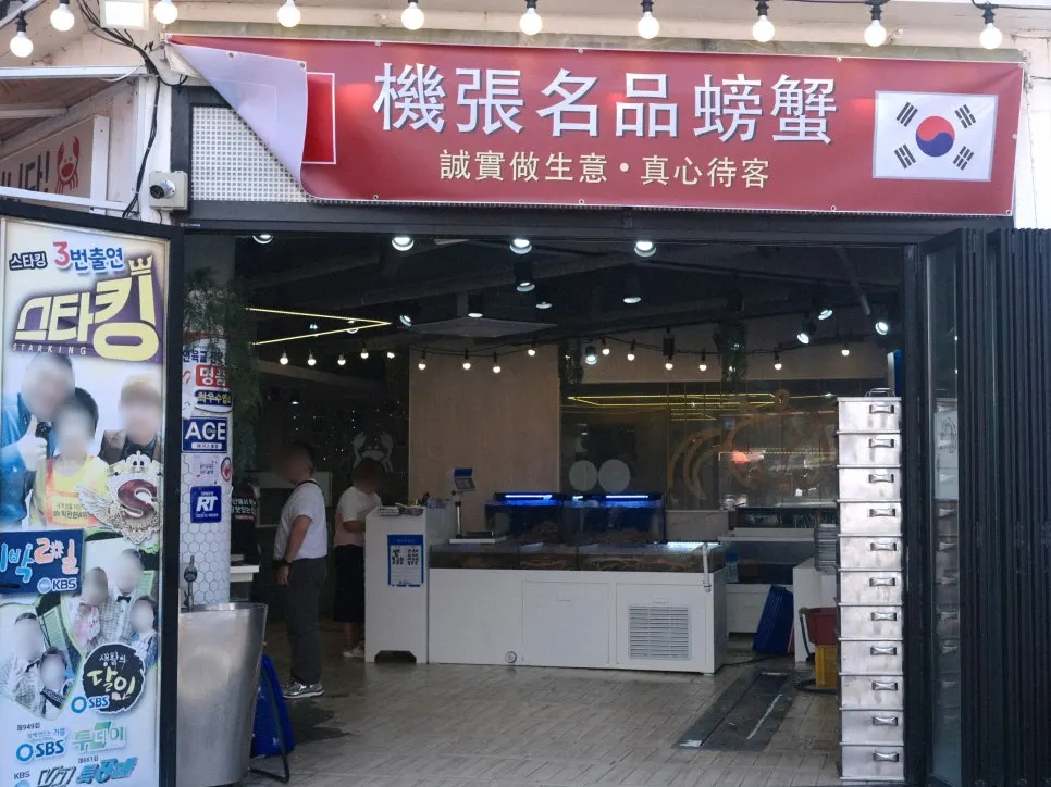 Storefront entrance with TV appearance notices posted