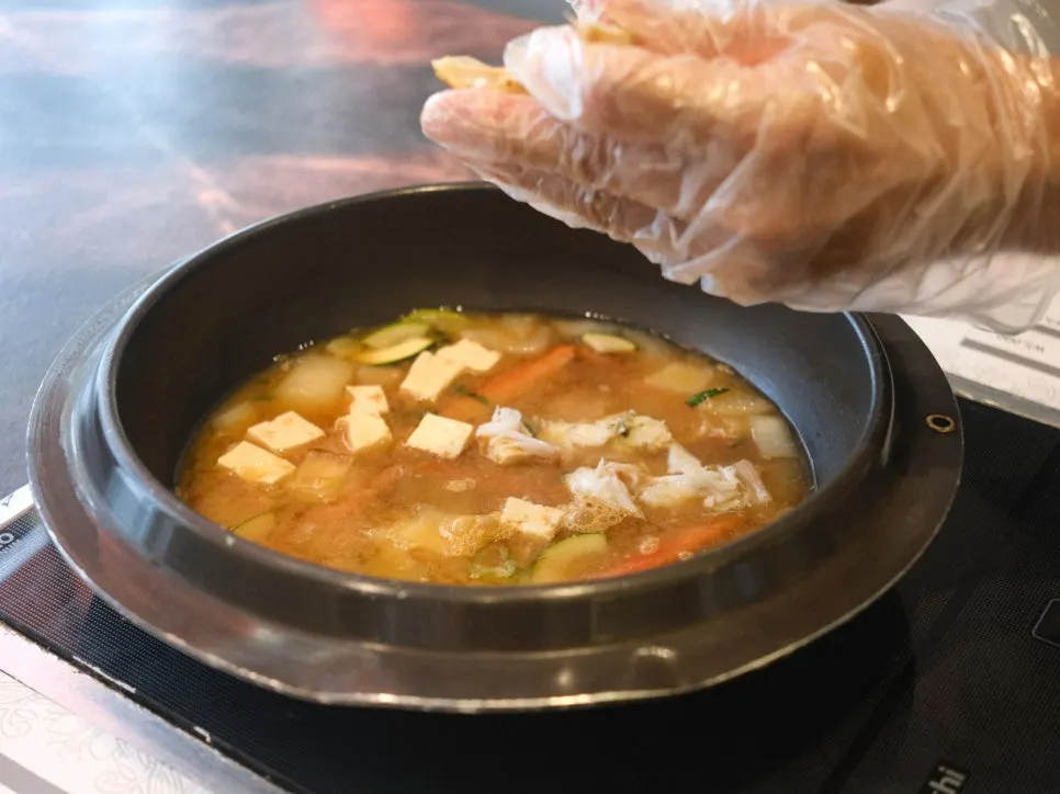 Doenjang stew with tofu, zucchini, and crab leg