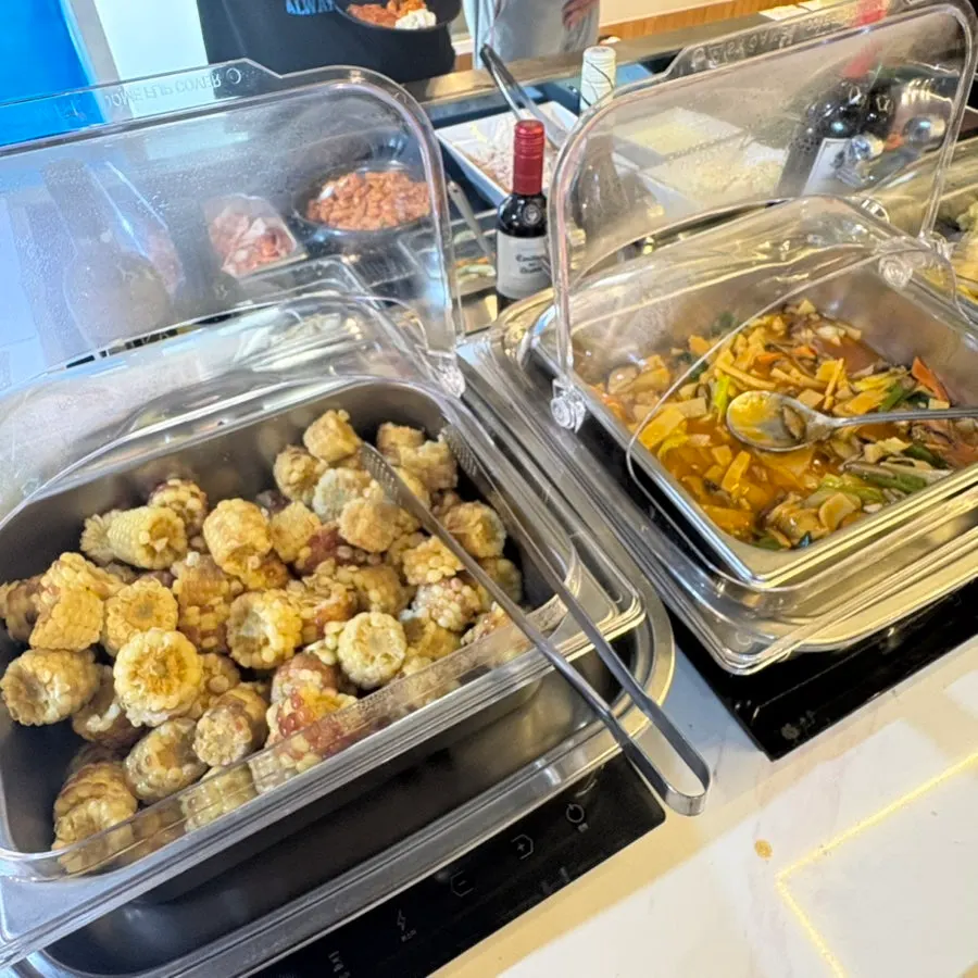 Self-serve bar with quail eggs, pickles, kimchi, and salads