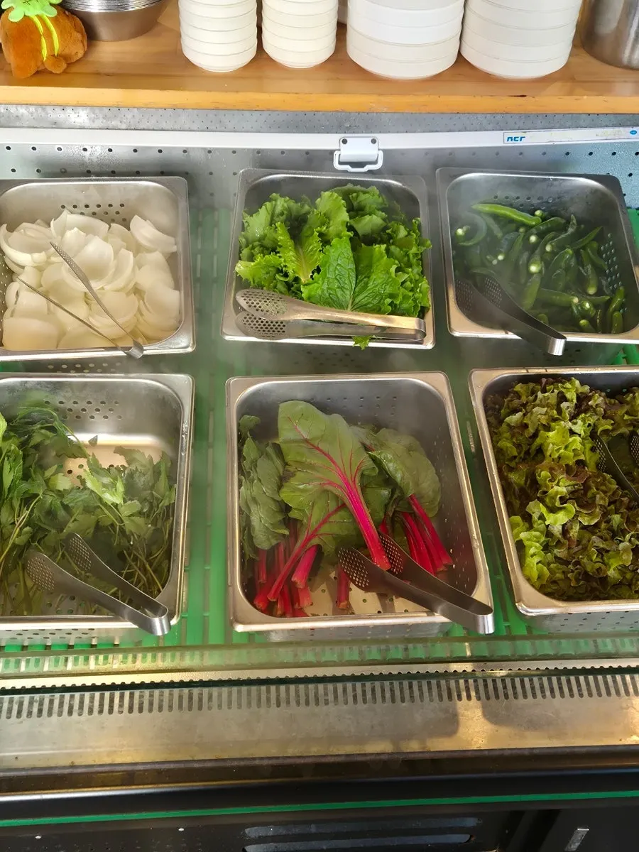 A self-serve bar stocked with various banchan