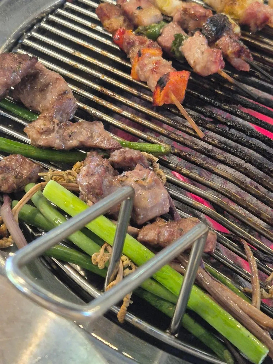 Handmade skewers cooking on the grill