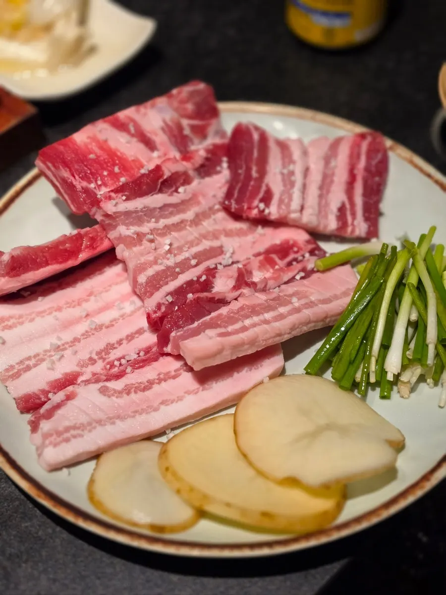 Fresh pork ribs served with potato and green onion