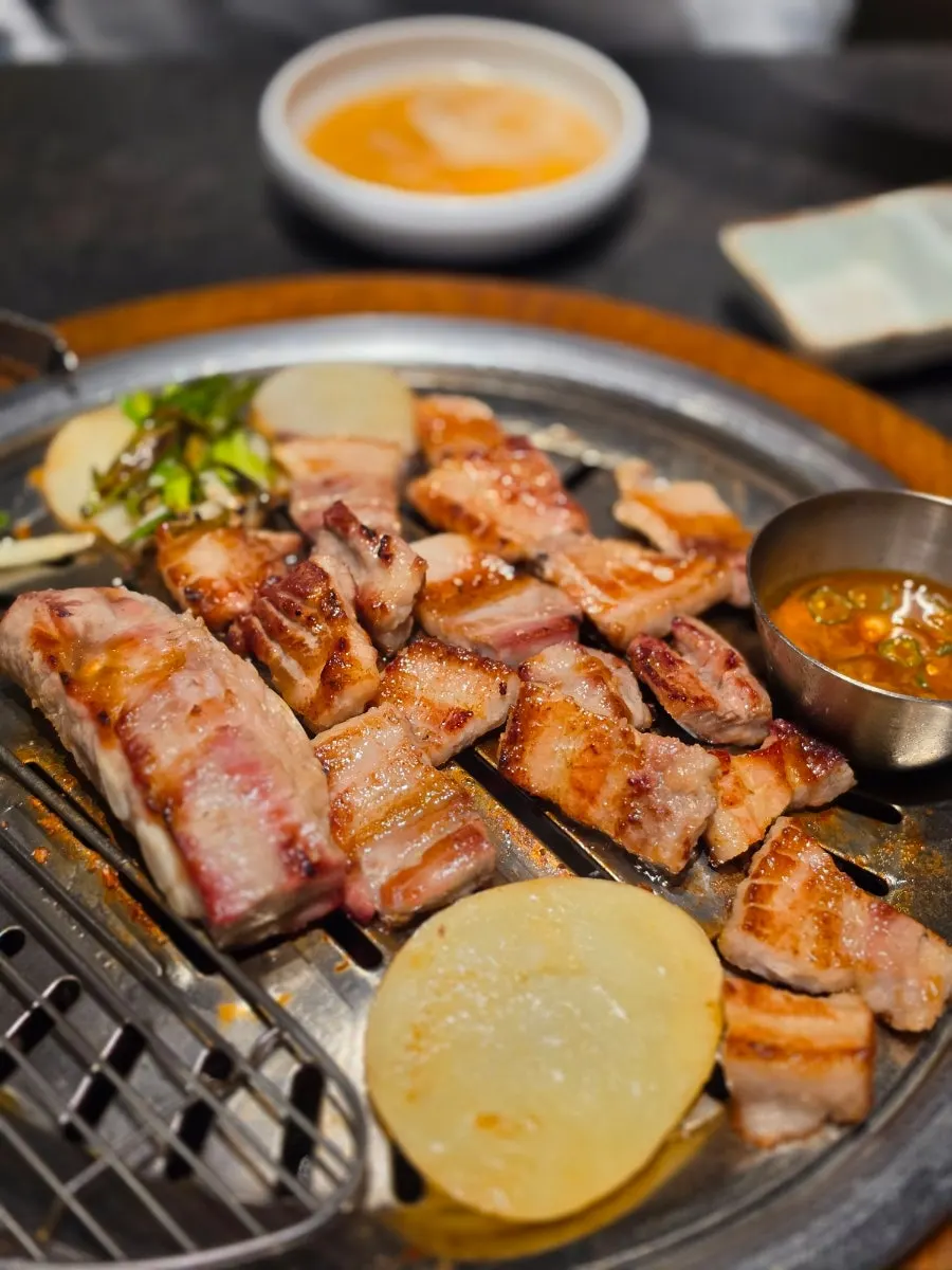 Charcoal-grilled pork ribs browning nicely