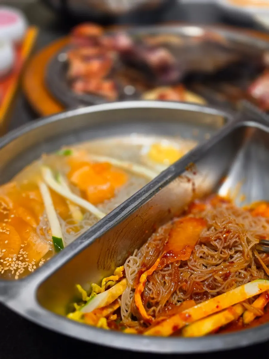 Mixed naengmyeon tossed together with grilled ribs on the side