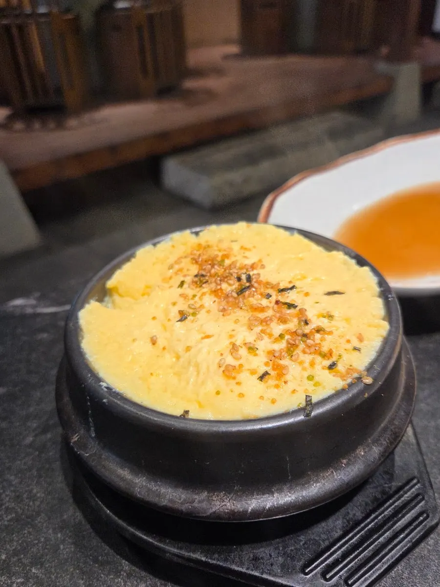 Egg soufflé puffed up in a stone bowl
