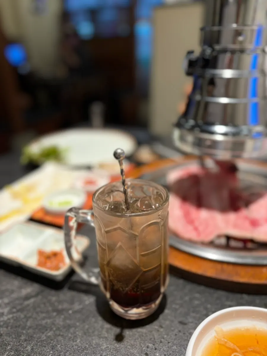A glass of plum highball with ice