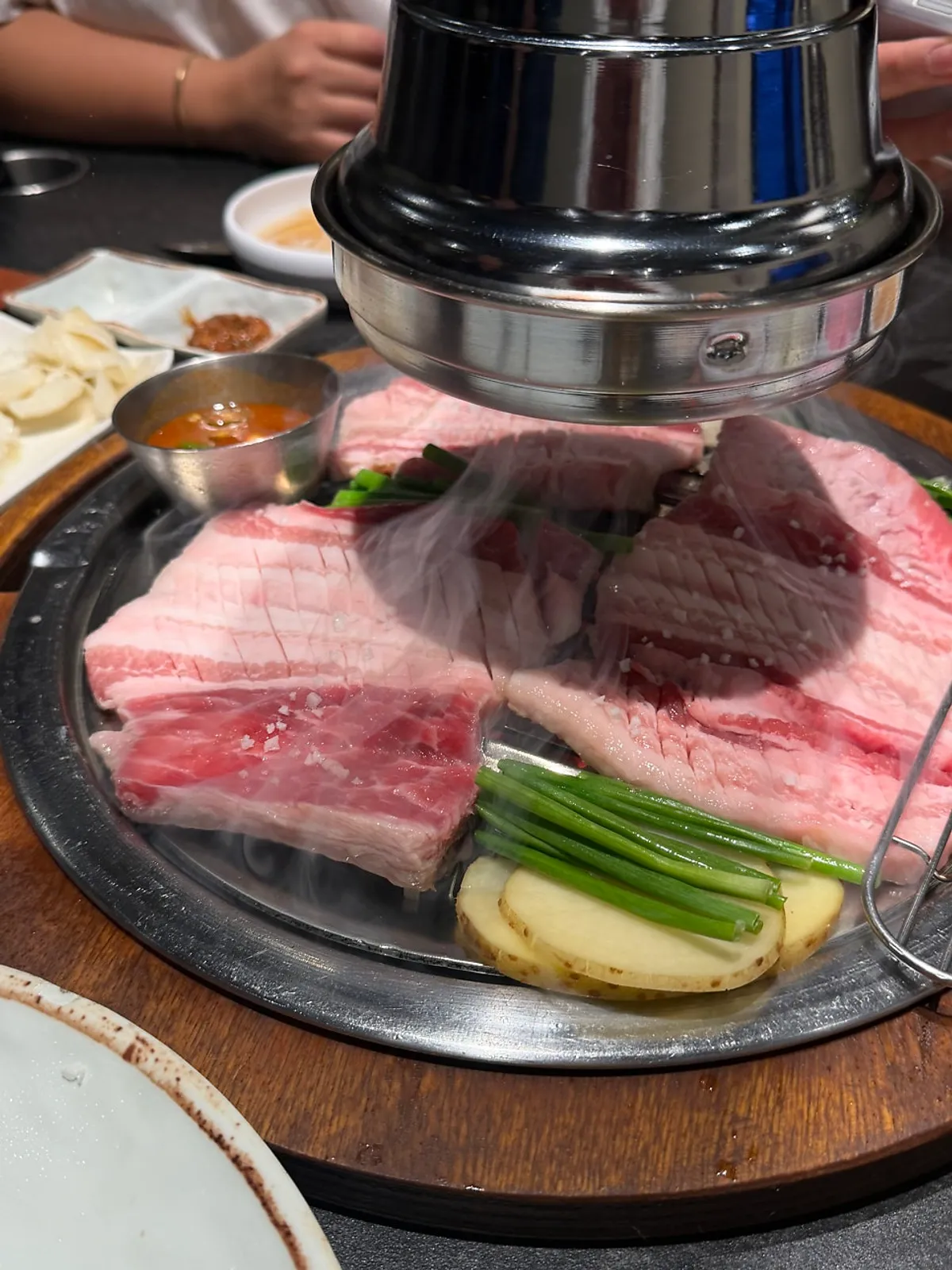 Table setting with a platter of fresh pork galbi from Gilchon